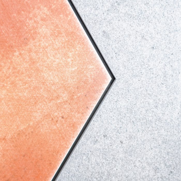 Detailaufnahme einer Fliese in Orange und Grau